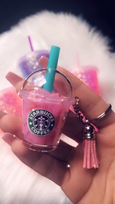 a hand holding a starbucks drink key chain