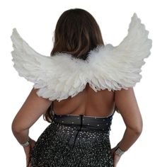 the back of a woman with large white wings