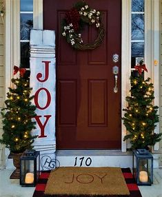 a front door decorated for christmas with candles and wreaths