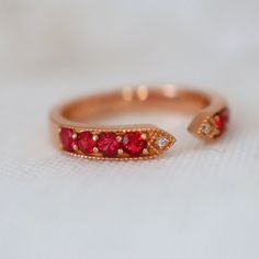 This ring features red spinels and diamonds with the most fascinating red color. The size 6.75 ring is made of solid 18K gold can be sized up or down for $65 if needed. This item is brand new and was appraised by a gemologist. The certificate will be included and describes the spinel as follows: Condition: Brand New & Custom Designed by me  Size: US 6.75 sizable  Metal: Solid 14K Rose Gold  Center Stone: Vivid Red Spinels 0.62ct.  Side Stones: Earth Mined Diamonds 0.05ct  Measurement: 4mm front Luxury Red Diamond Ring With Single Cut Diamonds, Luxury Red Rings With Diamond Accents, Luxury Red Rings With Rose Cut Diamonds, Red Diamond Ring With Single Cut Diamonds, Luxury Red Rose Cut Diamond Rings, Fine Jewelry Red Diamond Ring With Rose Cut, Red Diamond Open Ring, Red Rings With Diamond Accents For Anniversary, Red 14k Gold Rings With Diamond Accents