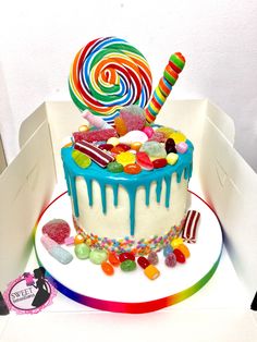 a birthday cake decorated with candy and lollipops