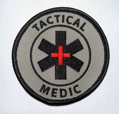 a patch with the words, medical and an emt cross in red on it