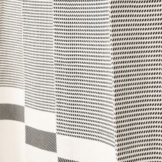 a black and white checkered fabric with an interesting pattern on the front, as well as in the back