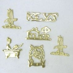 some gold colored metal items on a white surface