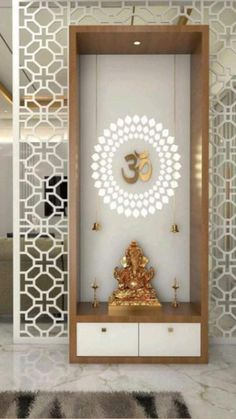 a room with a white wall and gold decorations on the walls, along with a buddha statue