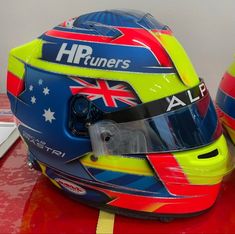 a helmet with the words hp runners on it sits next to another helmet that has an australian flag design