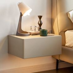 a table with a lamp and a cup on it