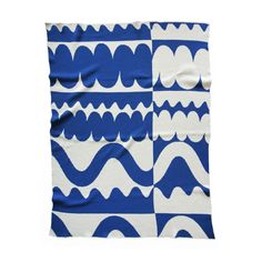 a blue and white blanket with wavy lines on it