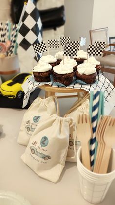 a table topped with cupcakes covered in frosting