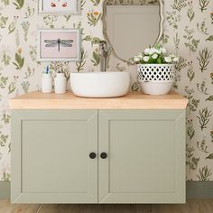 a bathroom with a sink, mirror and wallpaper on the walls in different colors