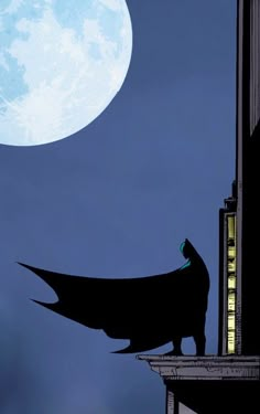 the silhouette of a batman standing on top of a building at night with a full moon in the background