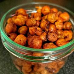 a glass jar filled with nuts on top of a table