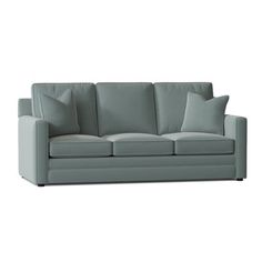 a light green couch with two pillows on it's back and one arm facing the camera