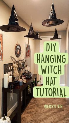 a living room decorated for halloween with witches hats on the ceiling and decorations hanging from the ceiling