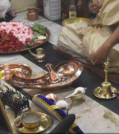 people sitting at a table with plates and bowls