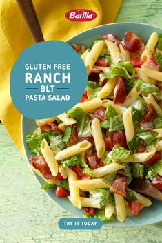 a bowl filled with pasta salad on top of a green table