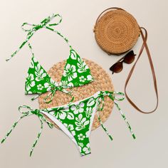 Indulge in the luxurious and exclusive style of our White Hawaiian Flowers on Fresh Green String Bikini. This beautiful string bikini set is not only comfortable, but it also offers double-layering and UPF 50+ protection. Customize the straps to your liking and get ready to turn heads at the beach! Made from soft recycled polyester, this bikini is both stylish and sustainable. • Soft and stretchy material with UPF 50+ • Sizes up to 6XL • Bikini top comes with removable padding for comfort • Mult Adjustable Swimwear For Vacation, String Swimwear For Beach Season Vacation, String Swimwear For Beach Vacation, String Swimwear For Vacation And Beach Season, Tropical Strappy Swimwear For Poolside, Adjustable Tropical Swimwear For Pool, Adjustable String Swimwear For Pool, Beachy String Swimwear For Beach, Beach String Swimwear With Adjustable Straps