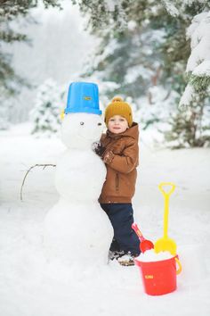 a little boy standing next to a snowman in the snow with text overlay that reads, 13 winter solstice traditions