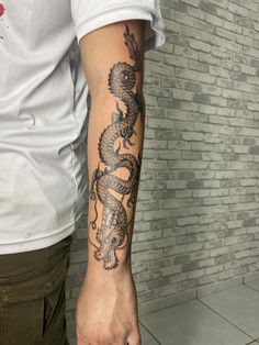 a man with a dragon tattoo on his arm