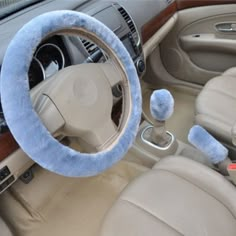 a car steering wheel cover with blue fuzzy balls