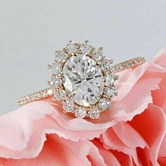 a close up of a flower with a diamond ring on it