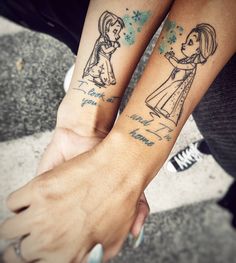 two people holding hands with tattoos on their arms, one has a girl and the other is a boy