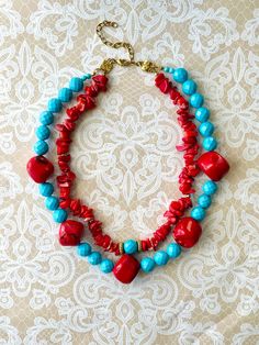 Beautiful and stunning Coral and turquoise necklace. Necklace length 16 inches. Vibrant Red Jewelry With Colorful Beads, Red Double Strand Gemstone Bead Necklaces, Vibrant Red Beaded Necklace For Gift, Vibrant Red Beaded Necklace, Handmade Red Turquoise Necklace For Jewelry Making, Handmade Red Turquoise Necklace As Gift, Handmade Vibrant Red Beaded Necklaces, Handmade Vibrant Red Beaded Necklace, Vibrant Red Handmade Beaded Necklace