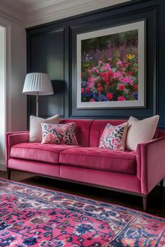 a living room with pink couches and rugs in front of a painting on the wall