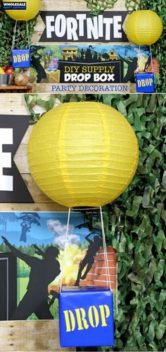 some yellow paper lanterns hanging from the side of a wooden wall with photos on it