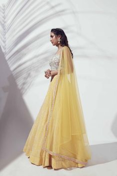 This beautiful yellow thread embroidered lehenga is paired with a colorful thread embroidered bustier blouse with hooks at the back. This outfit is completed with a net yellow dupatta with borders on two sides. Traditional Yellow Gown With Intricate Embroidery, Yellow Semi-stitched Gown With Cutdana Details, Semi-stitched Yellow Gown With Cutdana, Yellow Semi-stitched Cutdana Gown, Yellow Anarkali Set With Sheer Dupatta For Reception, Yellow Organza Sharara For Navratri, Yellow Anarkali Gown With Zari Work, Yellow Anarkali Pre-draped Saree With Dupatta, Yellow Anarkali Style Organza Pre-draped Saree