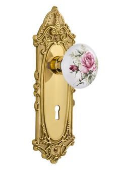 a door handle with a rose painted on the front and side panel, in gold