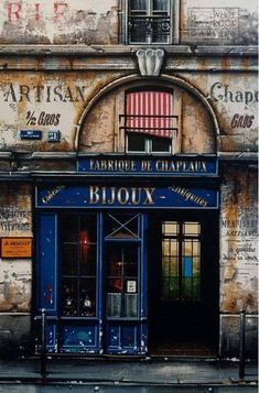 an old building with blue doors and windows on the outside, in front of it is a sign that reads bloux