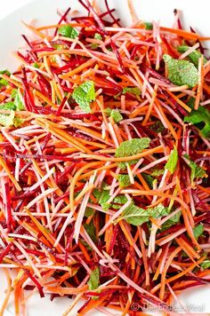 shredded carrots and radishes on a white plate