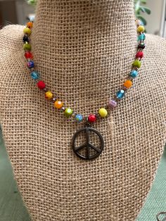 "The Happy Hippie Necklace is handbeaded with colorful Millefiori Italian Glass beads and Czech Glass beads.  Vintage Spirit Design Jewelry incorporates vintage elements into all of our jewelry. This is our way of recycling and reusing many beautiful pieces of jewelry that served their purpose in one form.  The Peace Sign Pendant on this necklace is 1\" in diameter.  The necklace comes in Silver or Antique Bronze. The hardware matches the metal of the Peace sign - so please choose which one you Cheap Adjustable Jewelry With Peace Sign, Cheap Colorful Hippie Beads, Hippie Jewelry Diy, Hippie Things, Hippie Glasses, Beaded Rainbow, Hippie Crafts, Hippie Accessories, Spirit Design