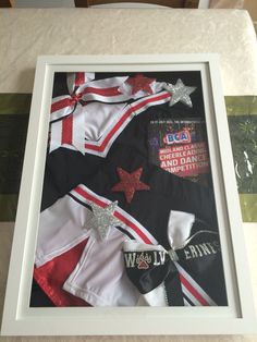 a framed photograph of cheerleader's uniform