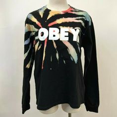 Heavyweight, 100% Cotton, Long Sleeve Jersey T-Shirt Relaxed, Slightly Oversized Fit Obey Graphic On Chest Ribbed Collar And Cuffs Spiral Tie Dye Wash Gives Shirt A Soft Feel And A Unique, Faded Look Mannequin Is Wearing A S Please Note: Tie Dye Pattern May Differ From Photos Color: Black/Rainbow -- Size: Small Pit To Pit: 19.5" Neckline To Bottom: 22.5" Pit To End Of Sleeve: 22.5" Tie Dye Crew Neck Top For Streetwear, Multicolor Letter Print Tops For Streetwear, Casual Tie Dye Tops For Streetwear, Multicolor Grunge Top For Streetwear, Multicolor Relaxed Fit Tops For Streetwear, Multicolor Letter Print Grunge Tops, Casual Black Tops With Rainbow Print, Oversized Multicolor Top For Streetwear, Oversized Tie Dye Tops With Letter Print