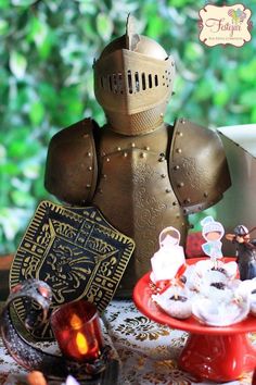 a knight figurine sitting on top of a table next to a plate of food