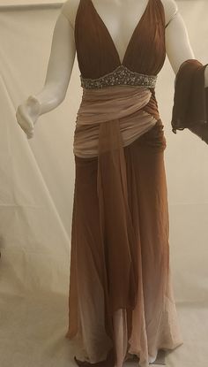 a mannequin dressed in a brown dress with beading on it's waist