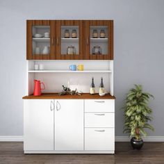 a kitchen with white cabinets and wooden counter tops, along with a potted plant