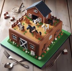 a cake shaped like a barn with horses on it