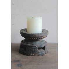 a white candle sitting on top of a wooden table