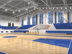 an empty basketball court with blue seats