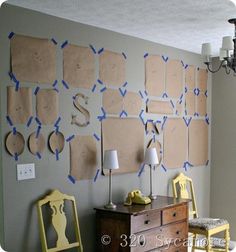 a room with several pieces of paper taped to the wall and some chairs in front of it