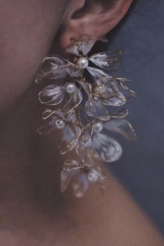 a close up of a person's ear with flowers attached to it