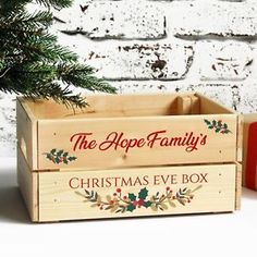 a christmas eve box sitting next to a small tree