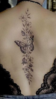 a woman with a butterfly tattoo on her back