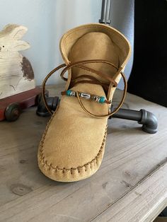 These handmade moccasins will not disappoint. A soft supple suede with a different way to tie them, handcrafted into a pair of unique. stylish, and comfortable pair of moccasins; accented with stone and metal beads. This particular pair is made with an extra leather sole sewn on for better outside wear., Made completely of leather and lined with an additional insole of leather. This configuration is ideal for earthing/grounding. This may be substituted with a synthetic sherpa type pad inside at Leather Moccasins Diy, Moccasin Patterns, Baby Moccasin Pattern, Diy Moccasins, Native American Moccasins, Handmade Moccasins, Moccasin Pattern, Earthing Grounding, Classic Clothes