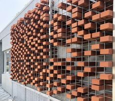 an orange brick wall with metal bars on it