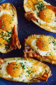 an egg is sitting on top of some potato wedges with cheese and chives