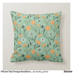 a green pillow with orange dandelions on it